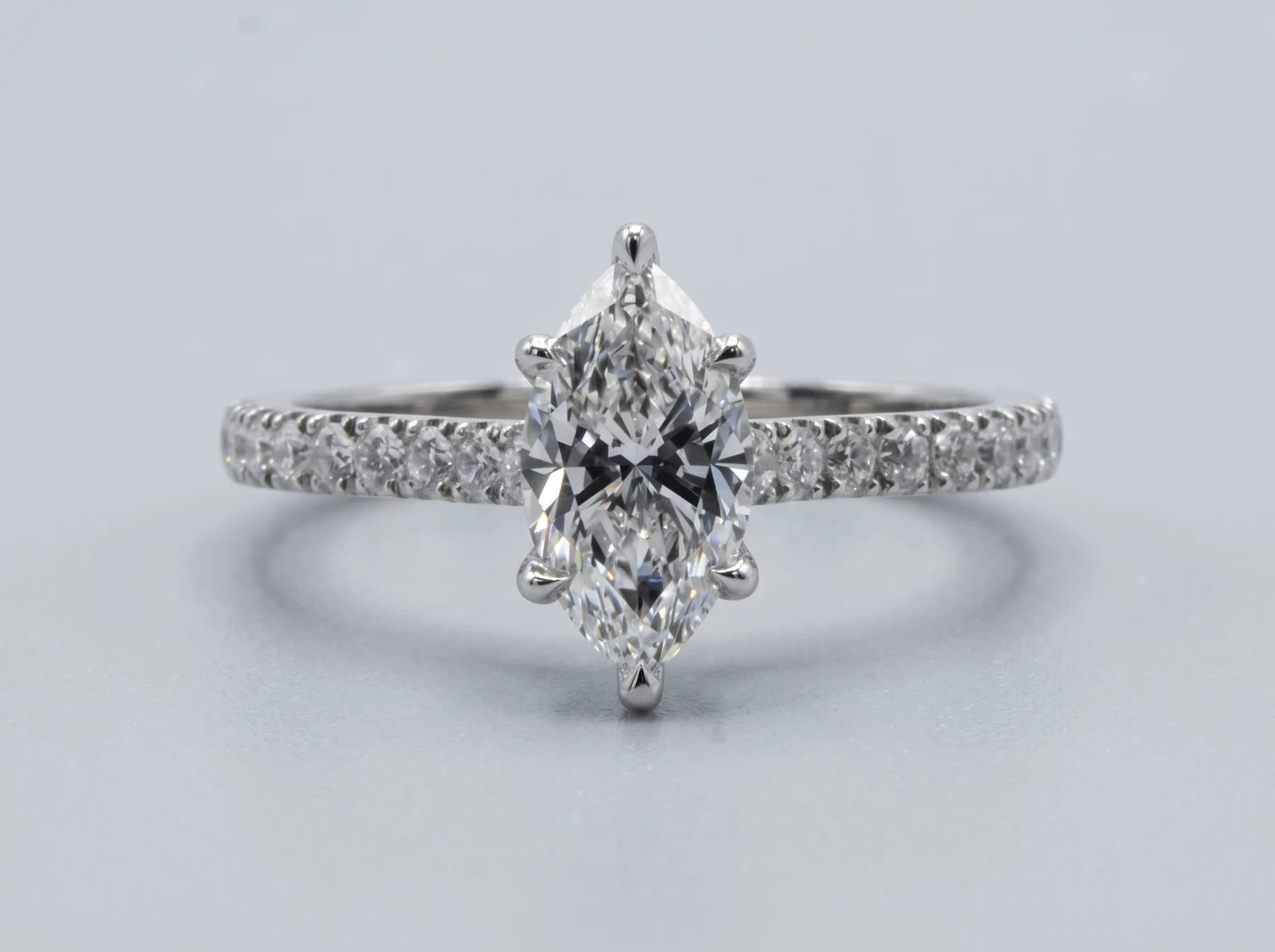 Marquise-cut stone in a ring with small stones along the band