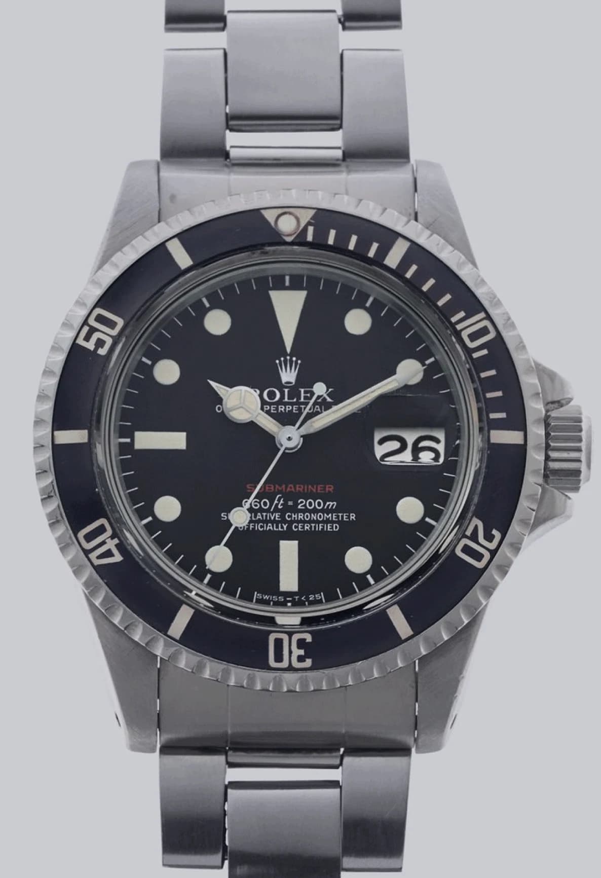 Vintage Rolex Submariner with a black dial, red Submariner lettering and a steel bracelet