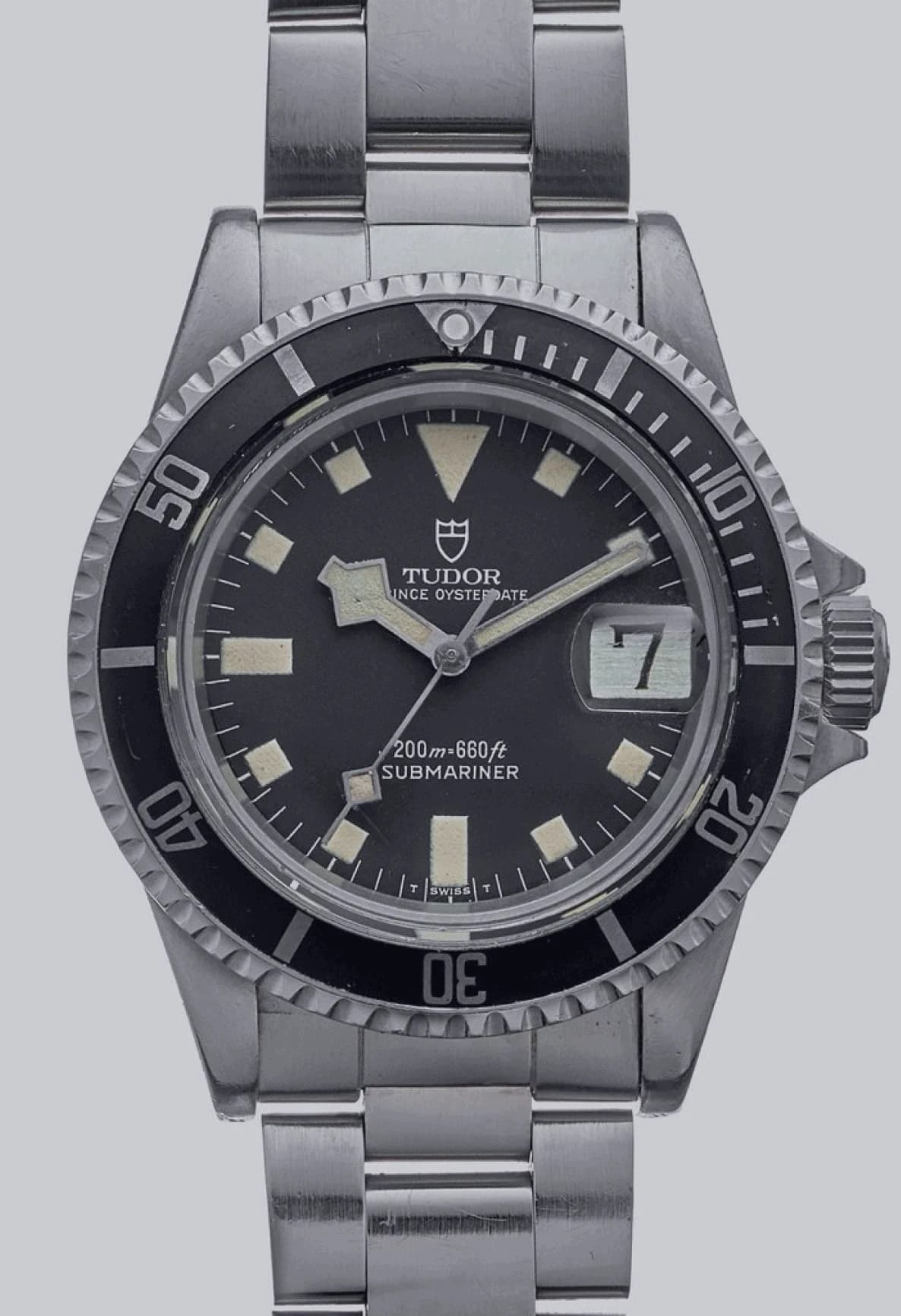 Black diving-watch dial with square hour markers, a snowflake hand and a date window